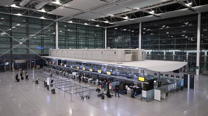 Passengers arrive with their luggage at a Lufthansa check-in counter at the Munich Airport in Munich, Germany, Thursday, Feb 27, 2025. (Sven Hoppe/dpa via AP)