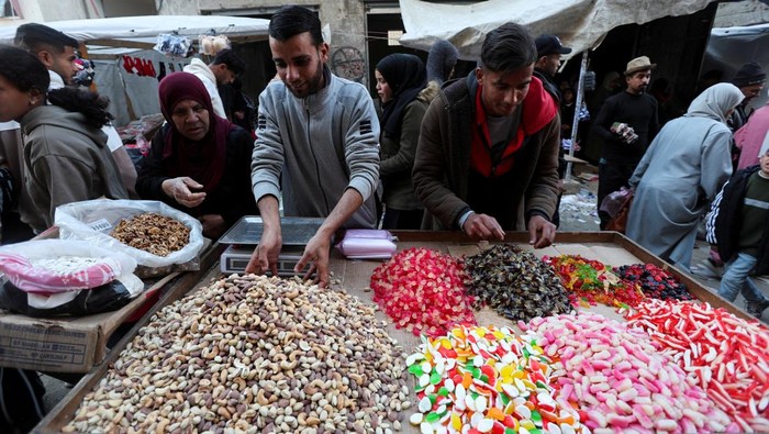 Palestinians shop as they prepare for the upcoming holy fasting month of Ramadan, amid a ceasefire between Israel and Hamas, in Khan Younis, in the southern Gaza Strip, February 27, 2025. REUTERS/Ramadan Abed     TPX IMAGES OF THE DAY