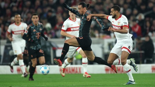 STUTTGART, GERMANY - FEBRUARY 28: Leroy Sane of Bayern Munich runs with the ball whilst under pressure from Josha Vagnoman of VfB Stuttgart during the Bundesliga match between VfB Stuttgart and FC Bayern München at MHPArena on February 28, 2025 in Stuttgart, Germany. (Photo by Alex Grimm/Getty Images)