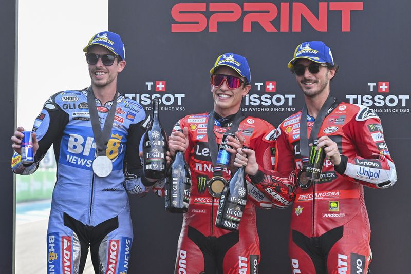 MotoGp Spain's Marc Marquez, center, second placed Spain's Alex Marquez, left, and third placed Italy's Francesco Bagnaia celebrate on the podium after the MotoGP sprint race at the Chang International Circuit in Buriram, Thailand, Saturday, March 1, 2025. (AP Photo/Kittinun Rodsupan)