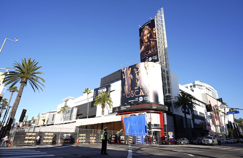 Signs advertise Sunday's 97th Academy Awards at the Dolby Theatre on Wednesday, Feb. 26, 2025, at the intersection of Hollywood Blvd. and Highland Ave. in Los Angeles. (AP Photo/Chris Pizzello)