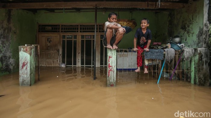 Warga memperkuat di dalam rumah saat banjir di Kawasan Bidara Cina, Jakarta, Senin (3/3/2025).