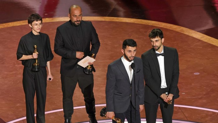 No Other Land HOLLYWOOD, CALIFORNIA - MARCH 02: (L-R) Rachel Szor, Hamdan Ballal, Basel Adra and Yuval Abraham accept the Documentary Feature Film award No Other Land onstage during the 97th Annual Oscars at Dolby Theatre on March 02, 2025 in Hollywood, California. (Photo by Kevin Winter/Getty Images)