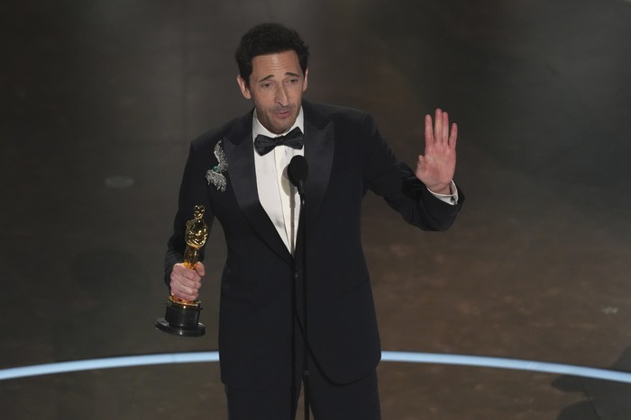 Adrien Brody celebrates with Georgina Chapman after winning the award for best performance by an actor in a leading role for 