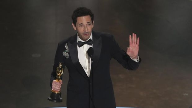 Adrien Brody celebrates with Georgina Chapman after winning the award for best performance by an actor in a leading role for 