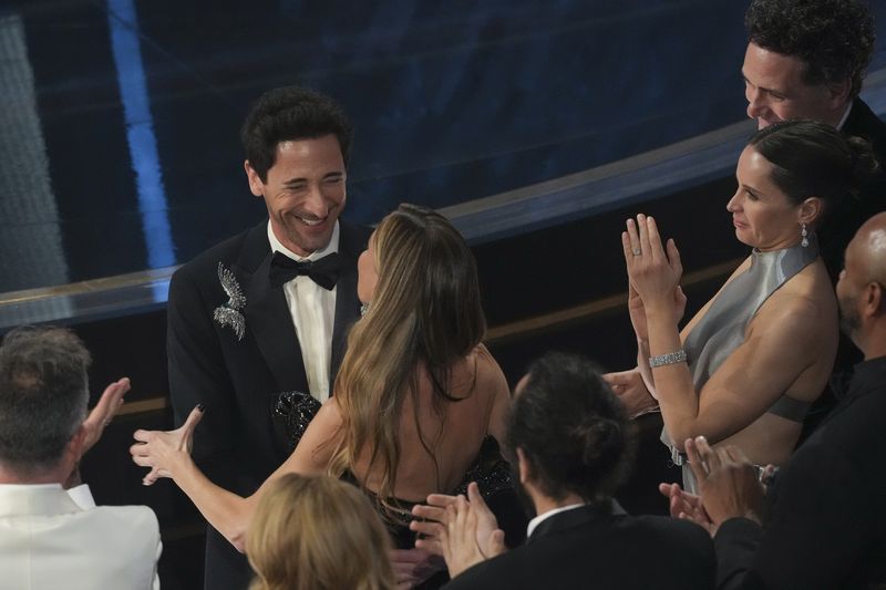 Adrien Brody celebrates with Georgina Chapman after winning the award for best performance by an actor in a leading role for 