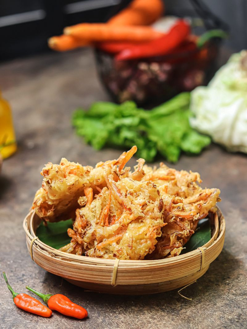 Bakwan Vegetable, or Bala-Bala, or OTE-OTE, OR VEGETABLE FRITTER, is an Indonesian Snack Made from Flour, Cabbage, Carrots, and Bean Sprouts, Served with Chili Pepper, Peanut Sauce, or Sambal