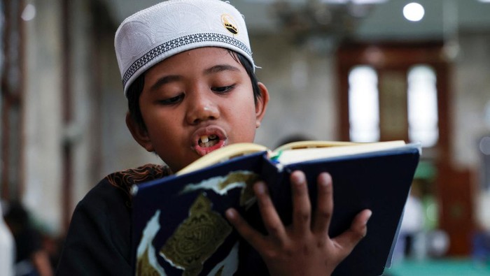 A Muslim man reads the verses of Koran from his smartphone at Cut Meutia mosque, during the holy fasting month of Ramadan, in Jakarta, Indonesia March 3, 2025. REUTERS/Willy Kurniawan