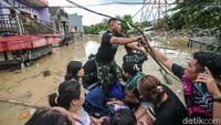 Kabel yang melintang membuat tim SAR kesulitan menembus banjir. 