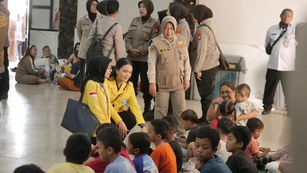 Polri mengajak mahasiswa UI, Belva Catalina D dan Dita Puspita, memberikan layanan trauma healing kepada warga korban banjir di Jakarta Timur, Rabu (5/3/2025).