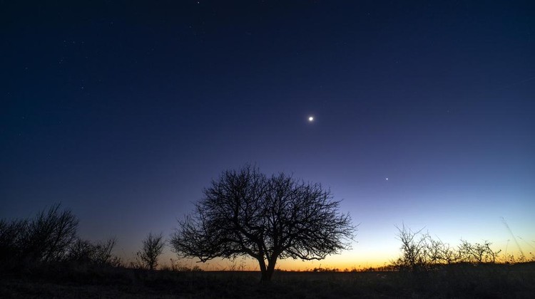 The conjunction of planet Jupiter, from left, the Moon and planet Venus is seen in the sky near Salgotarjan, Hungary, Monday, March 3, 2025. (Peter Komka/MTI via AP)