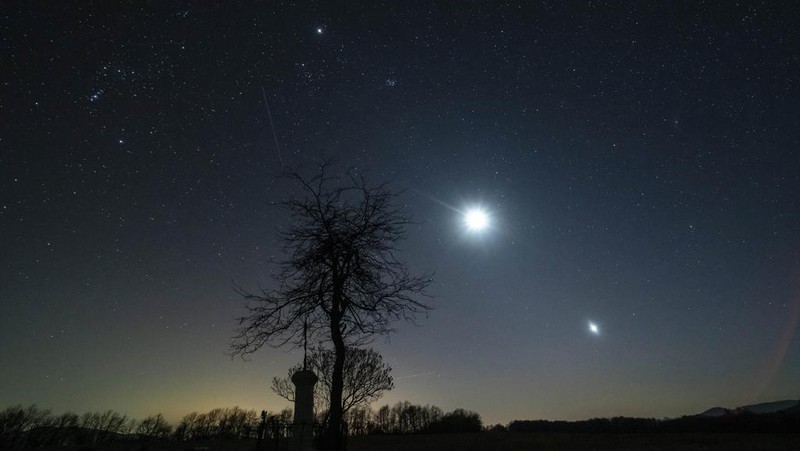 The conjunction of planet Jupiter, from left, the Moon and planet Venus is seen in the sky near Salgotarjan, Hungary, Monday, March 3, 2025. (Peter Komka/MTI via AP)