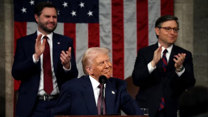 WASHINGTON, DC - MARCH 04: U.S. President Donald Trump addresses a joint session of Congress at the U.S. Capitol on March 04, 2025 in Washington, DC. Vice President JD Vance and Speaker of the House Mike Johnson (R-LA) applaud behind him. Win McNamee/Pool via REUTERS Purchase Licensing Rights