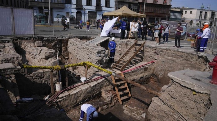 A worker stands inside what was a colonial bridge from XVI century as it is excavated behind the government palace in Lima, Peru, Monday, Feb. 24, 2025. (AP Photo/Martin Mejia)
