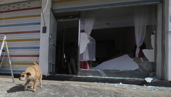 A police officer controls damaged area near the site of an accidental bombing in Pocheon, South Korea, Thursday, March 6, 2025. (AP Photo/Lee Jin-man)