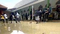 Guru dan siswa Sekolah Daar El-Salam yang berada di wilayah Villa Nusa Indah 2 membersihkan lingkungan sekolah usai banjir.  