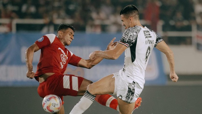 Striker Bali United, Boris Kopitovic (putih) berebut bola dengan bek Persis Solo, Jose Cleyton, dalam laga di Stadion Manahan, Solo, Kamis (6/3/2025).