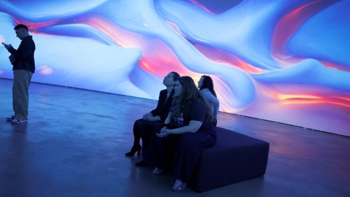 Visitors observe Living Architecture: Gehry, by Turkish-American media artist Refik Anadol, an audiovisual installation that reimagines Frank Gehry’s architectural legacy through artificial intelligence (AI) and generative art, at the Guggenheim Museum in Bilbao, Spain, March 6, 2025. REUTERS/Vincent West