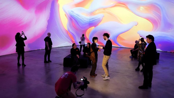 Visitors observe Living Architecture: Gehry, by Turkish-American media artist Refik Anadol, an audiovisual installation that reimagines Frank Gehry’s architectural legacy through artificial intelligence (AI) and generative art, at the Guggenheim Museum in Bilbao, Spain, March 6, 2025. REUTERS/Vincent West