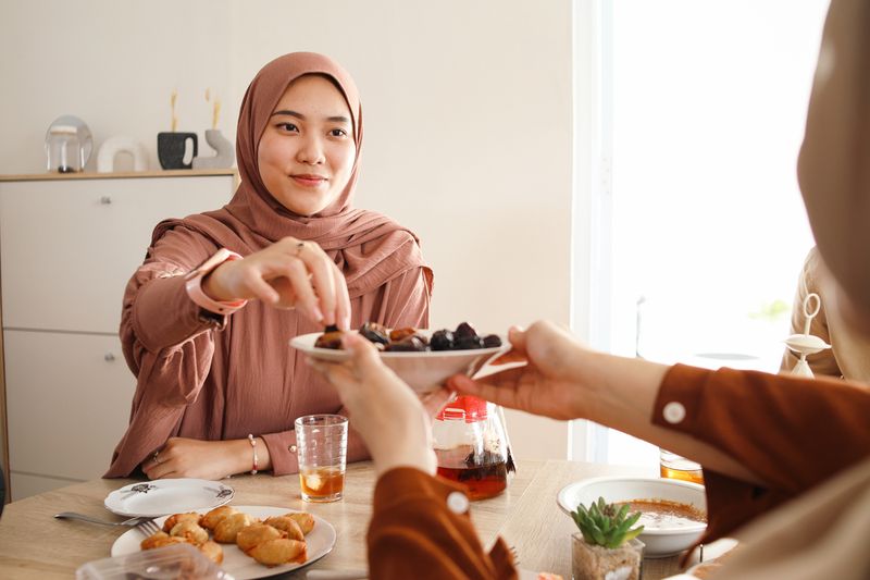 Asian muslim people eating and drinking together when breakfasting time