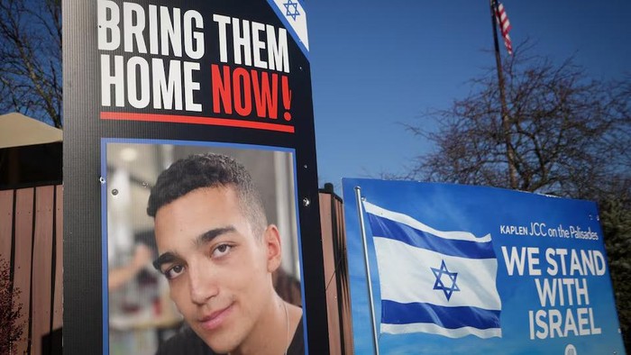 Signs and a photograph of Edan Alexander, the American-Israeli and Israel Defense Forces soldier taken hostage during the October 7, 2023 attack on Israel by Hamas, stand outside a Jewish community center in Alexander’s home town of Tenafly, New Jersey, U.S., December 14, 2024. REUTERS/Stephani Spindel/File Photo Purchase Licensing Rights
