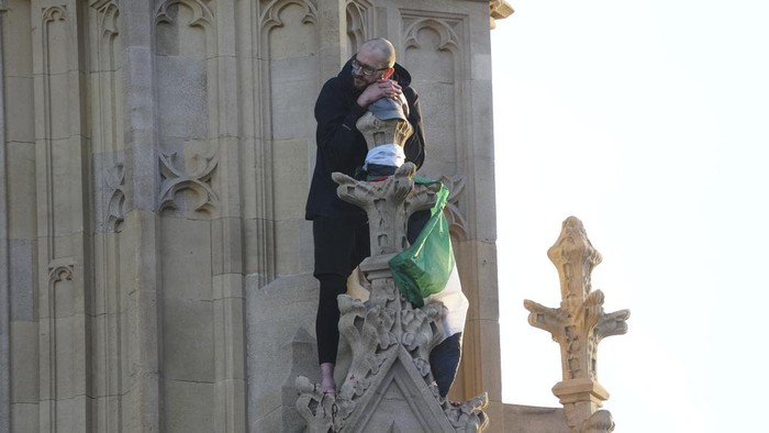 Emergency workers talk to a man after he climbed up Elizabeth Tower, which houses Big Ben, at the Palace of Westminster in London, Saturday, March 8, 2025. (Jeff Moore/PA via AP)