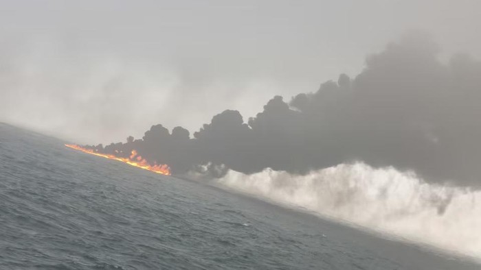 Smoke and flames rise from a collision between an oil tanker and cargo ship off the northeastern coast of England. BARTOSZ SMIALEK/via REUTERS Purchase Licensing Rights