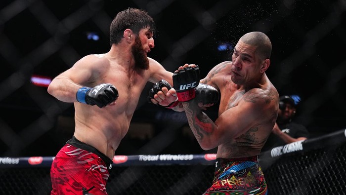LAS VEGAS, NEVADA - MARCH 08: (L-R) Magomed Ankalaev of Russia strikes Alex Pereira of Brazil in the UFC light heavyweight championship fight during the UFC 313 event at T-Mobile Arena on March 08, 2025 in Las Vegas, Nevada.  (Photo by Chris Unger/Zuffa LLC)