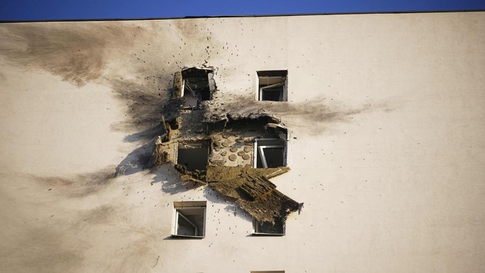 This photo shows an apartment building, top, where the downed Ukrainian drone fell at an area in Sapronovo village outside Moscow, Russia, on Tuesday, March 11, 2025. (AP Photo)