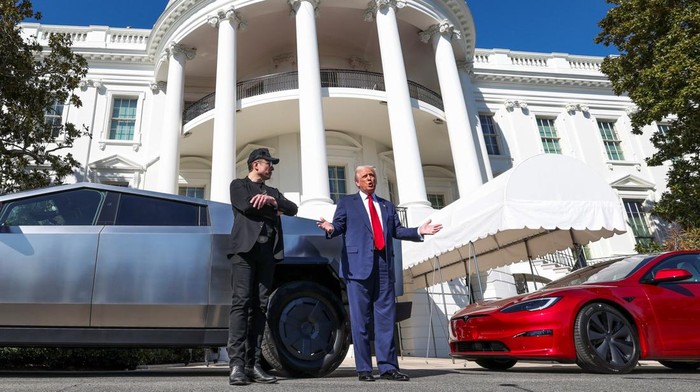 U.S. President Donald Trump talks to the media next to Tesla CEO Elon Musk, with Tesla cars in the background, at the White House in Washington, D.C., U.S., March 11, 2025. REUTERS/Kevin Lamarque