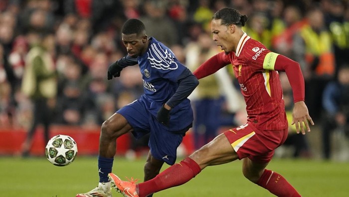 Liverpools Virgil van Dijk, right, challenges PSGs Ousmane Dembele during the Champions League round of 16 second leg soccer match between Liverpool and Paris Saint-Germain at Anfield in Liverpool, England, Tuesday, March 11, 2025. (AP Photo/Dave Thompson)