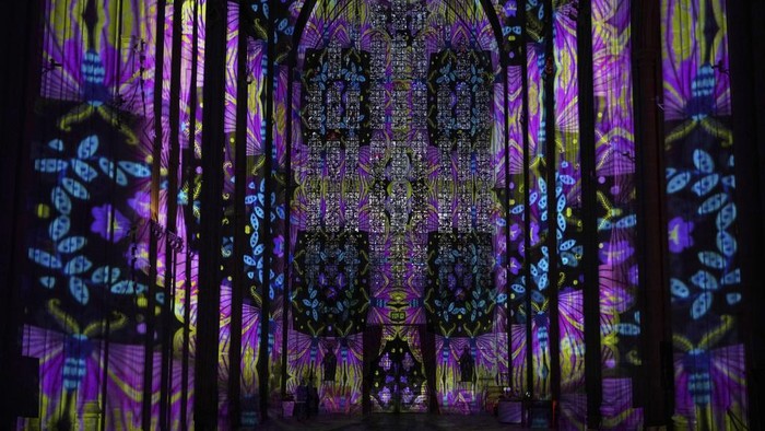 A sound and light show with a literary theme developed by Luxmuralis is screened inside Winchester Cathedral in Winchester, England, Tuesday, March 11, 2025. (AP Photo/Alastair Grant)