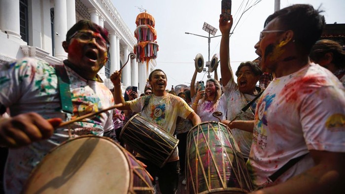 A woman uses a phone during Holi celebrations in Kathmandu, Nepal March 13, 2025. REUTERS/Navesh Chitrakar