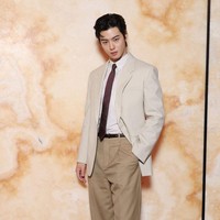 Tahun ini, Cha Eun Woo menampilkan office attire look di peragaan busana Saint Laurent. Bintang drama Korea True Beauty itu memadukan setelan jas berwarna krem, celana panjang senada, kemeja garis-garis, dan dasi berwarna burgundy. Foto: dok. Getty Images