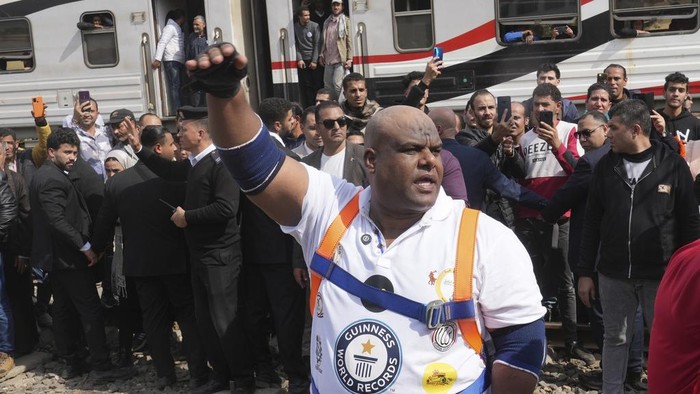 Egyptian wrestler Ashraf Mahrous, better known as Kabonga, pulls a train for nearly 10 meters, 33 feet, at Ramses Station in Cairo, Egypt, as he is watched by Guinness World Record observers, Thursday, March 13, 2025. (AP Photo/Amr Nabil) ID: