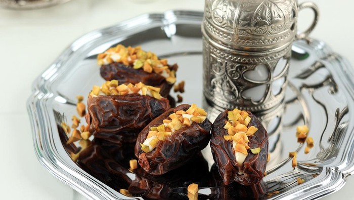 Dates Stuffed with Cream Cheese, Peanut Butter, and Pistachios. Served with Tea