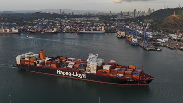 A cargo ship sails under Las Americas bridge through the Panama Canal, in Panama City, Thursday, March 13, 2025. (AP Photo/Matias Delacroix)