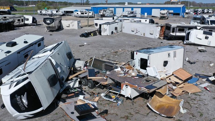 Lee Oliver, who works in sales, inspects the trailers and campers that lay torn apart at the Burton Campers saleyard after storms hit the area around Calera, Alabama, U.S, March 16, 2025.  REUTERS/Dane Rhys
