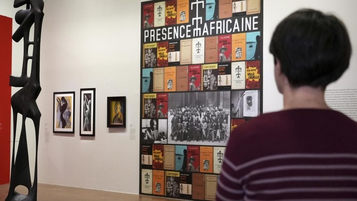 A man photographs the 1965 painting 