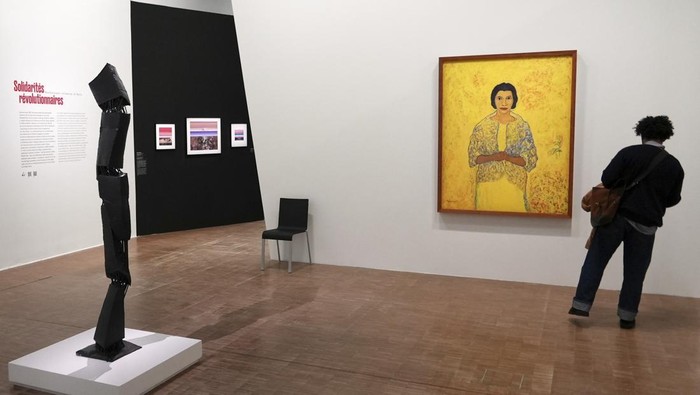A man photographs the 1965 painting 
