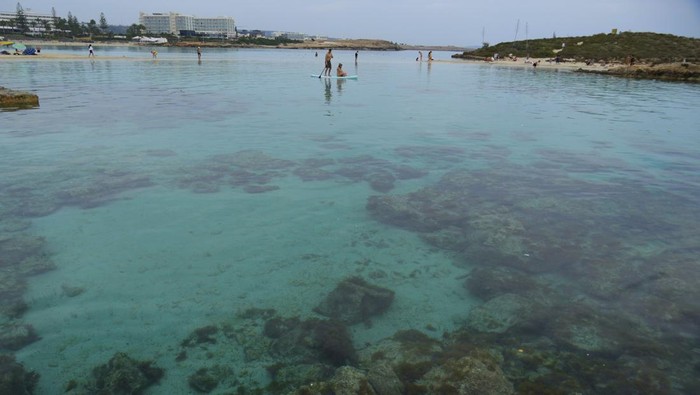 People enjoy the hot weather in the sea in Ayia Napa resort, in the easter Mediterranean island of Cyprus, Monday, March 17, 2025. (AP Photo/Petros Karadjias)