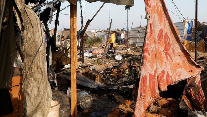 Palestinians inspect the site of an Israeli strike on a tent camp housing displaced people, in Al-Mawasi area, in Khan Younis in the southern Gaza Strip March 18, 2025. REUTERS/Hatem Khaled