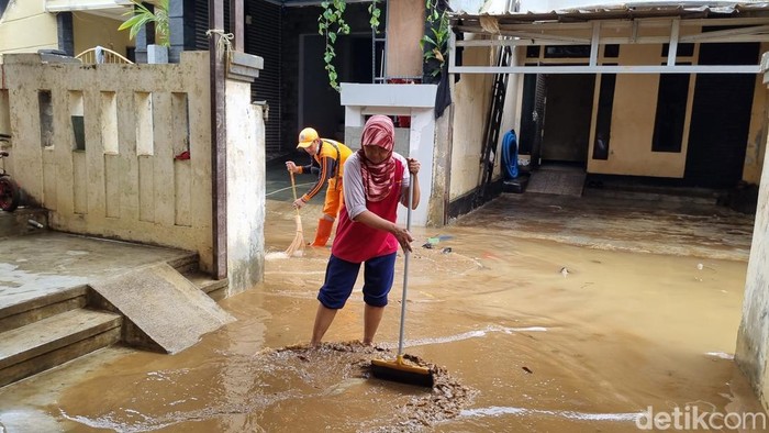 Warga Pejaten Timur kembali membersihkan lumpur sisa banjir. (Taufiq/detikcom)