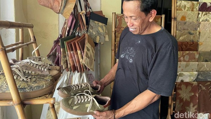 Asep Kartiwa menunjukkan sepatu batik dahon Pangandaran