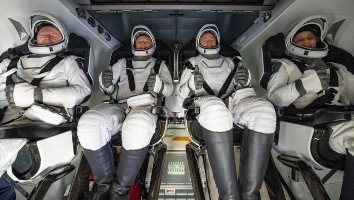 Support teams onboard the SpaceX recovery ship MEGAN work around a SpaceX Dragon spacecraft shortly after it landed with NASA astronauts Nick Hague, Suni Williams, Butch Wilmore, and Roscosmos cosmonaut Aleksandr Gorbunov aboard in the water off the coast of Tallahassee, Florida, Tuesday, March 18, 2025. NASA/Keegan Barber/ Handout via REUTERS