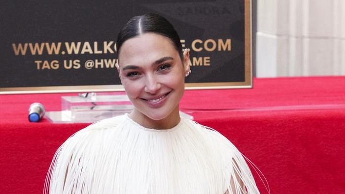 Jaron Varsano, left, and Gal Gadot pose atop Gadots new star at a ceremony on the Hollywood Walk of Fame on Tuesday, March 18, 2025, in Los Angeles. (Photo by Jordan Strauss/Invision/AP)