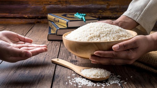Hands are holding a pile of grain to zakat, the Islamic zakat concept. Muslims to help the poor and needy. Conceptual shoot for property, income, and fitrah zakat.