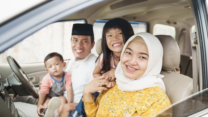 Muslim family travel by car during eid mubarak celebration. asian people going back to their hometown