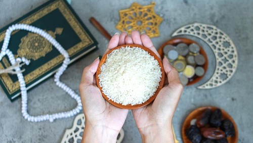 Muslim Hands Holding A Bowl Of Rice With Islamic Decoration On The Background
