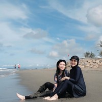 Sebagai ibu sambung, Irish juga kerap berlibur bersama Hassya dan Syifa. Dalam salah satu foto tampak Irish dan Hassya yang pose bareng di tepi pantai. Foto: Instagram/@_irishbella_